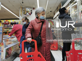A woman wears a face mask while doing shopping during coronavirus pandemic. Krakow, Poland on October 15th, 2020. Due to the increasing spre...