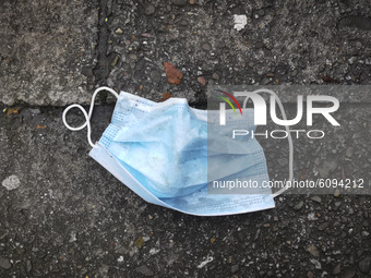 A  disposable face masks is seen lying on a pavemment during coronavirus pandemic. Krakow, Poland on October 16th, 2020. Due to the increasi...