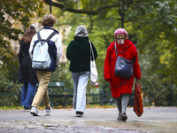 A woman wears a face shield while walking at Planty park during coronavirus pandemic. Krakow, Poland on October 16th, 2020. Due to the incre...