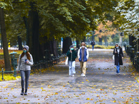 People wear face masks while walking through the Planty park during coronavirus pandemic. Krakow, Poland on October 16th, 2020. Due to the i...