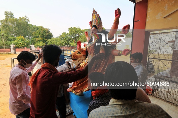 Jaipur: Devotees carry an idol of Goddess Durga as they load in pickup ahead of the Durga Puja festival, in Jaipur,Rajasthan ,India, Friday,...