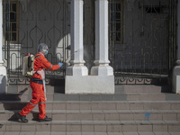 A city hall worker sprays disinfectant at a building in Kuala Lumpur, Malaysia, on  October 17, 2020. 
Malaysias capital state Kuala Lumpur...