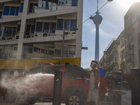 A firefighter sprays disinfectant at a pedestrian walkway in Kuala Lumpur, Malaysia, on  October 17, 2020. 
Malaysias capital state Kuala Lu...