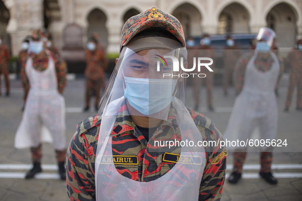 A firefighter wearing face shield before a disinfection process begin in Kuala Lumpur, Malaysia, on  October 17, 2020. Malaysias capital sta...