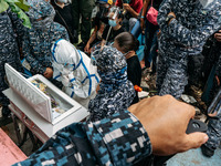 Political detainee Reina Mae Nasino, wearing full protective equipment and handcuffs, says her last goodbye to her three-month-old baby Rive...