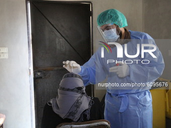 A team of doctors from the World Health Organization's Early Warning and Emergency Response Network (EWARN) wearing protective suits take sa...