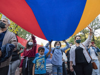 Protesters hold a huge armenian flag during a demonstration in Yerevan, Armenia, on October 16, 2020 for the recognition of Nagorno Karabakh...