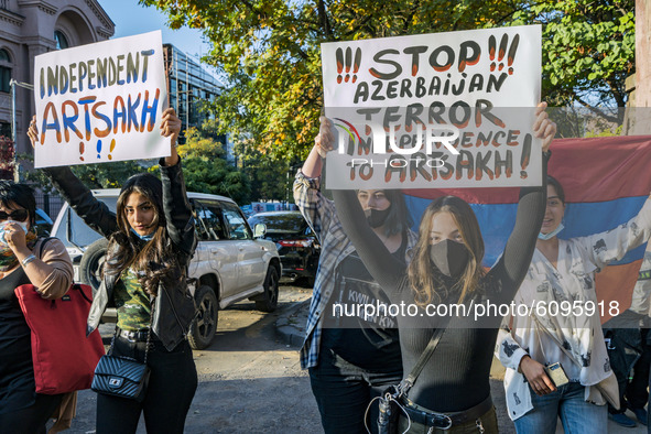 Protesters hold banners asking for stopping the conflict in Karabakh during a demonstration in Yerevan, Armenia, on October 16, 2020 for the...