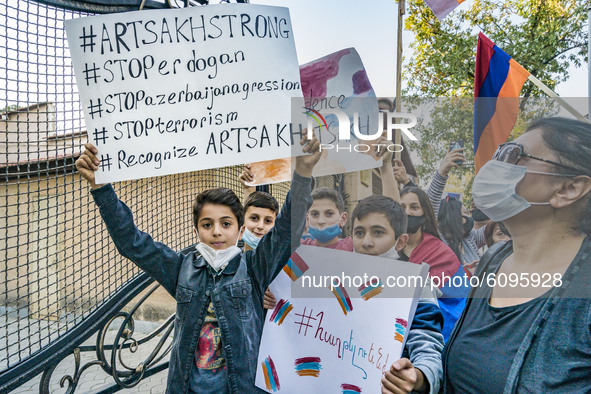 Kids hold banners asking for stopping the war with Azerbaijan in Karabakh during a demonstration in Yerevan, Armenia, on October 16, 2020 fo...