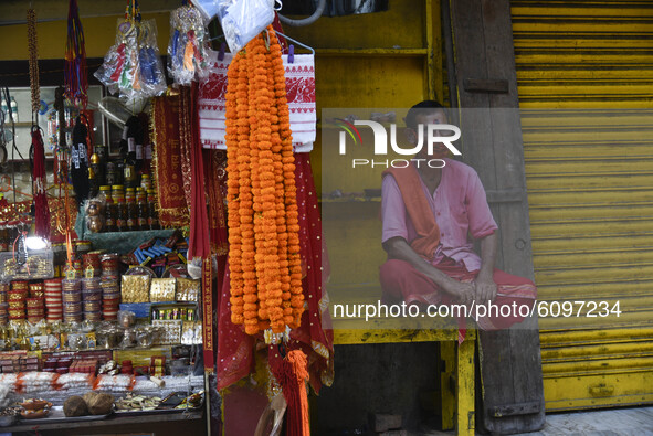 A vendor of  Navratri Puja Samagri waiting for customer outside Hindu temple Kamakhya during the first day of Navratri Festival, as very few...