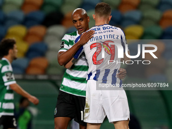 Joao Mario of Sporting CP (L) hugs Toni Martinez of FC Porto at the end of the Portuguese League football match between Sporting CP and FC P...