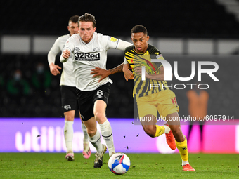
Joao Pedro of Watford battles with Max Bird, during the Sky Bet Championship match between Derby County and Watford at the Pride Park, Derb...