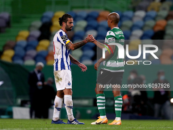 Joao Mario of Sporting CP (R ) shake hands with Sergio Oliveira of FC Porto at the end of the Portuguese League football match between Sport...