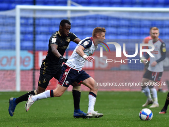 Bolton Wanderers' Ein Doyle  ands Oldham Athletic's Brice Ntambwe in action during the Sky Bet League 2 match between Bolton Wanderers and O...