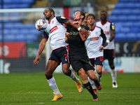 Boltons Nathan Delfouneso clashes with Oldhams Callum Whelan during the Sky Bet League 2 match between Bolton Wanderers and Oldham Athletic...
