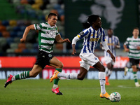 Romario Baro of FC Porto (R ) vies with Joao Palhinha of Sporting CP during the Portuguese League football match between Sporting CP and FC...