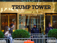 People wearing masks walk past the Trump tower as NYPD officers looks on. New York City continues Phase 4 of re-opening following restrictio...