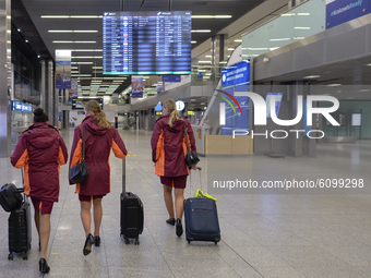 Three flight attendants walk in an empty Terminal Hall at Krakow's Airport.
Poland is the latest European country to tighten restrictions on...