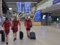 Three flight attendants walk in an empty Terminal Hall at Krakow's Airport.
Poland is the latest European country to tighten restrictions on...
