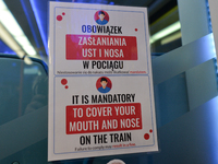 A COVID-19 related warning sign in a train from Krakow's Airport to Krakow City Center.
Poland is the latest European country to tighten res...