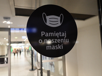 A sign reading 'Remember to wear a mask' seen at the entrance door to Galeria Krakowska Shopping Mall.
Poland is the latest European country...