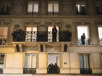 People are watching the street through their windows as this second night of curfew in Paris begins and for the first time this Saturday, Oc...