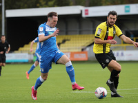 Josh Kay of Barrow in action with Harrogate Town's  Connor Hall during the Sky Bet League 2 match between Harrogate Town and Barrow at Wethe...