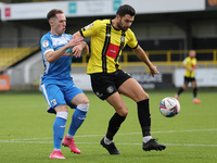 Josh Kay of Barrow in action with Harrogate Town's  Connor Hall during the Sky Bet League 2 match between Harrogate Town and Barrow at Wethe...