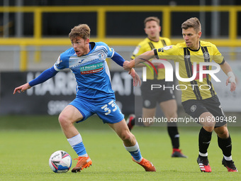 Barrow's Luke James in action with Harrogate Town's  Lloyd Kerry during the Sky Bet League 2 match between Harrogate Town and Barrow at Weth...