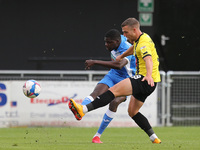 Yoan Zouma of Barrow clears from defence passed Harrogate Town's  Jack Muldoon during the Sky Bet League 2 match between Harrogate Town and...
