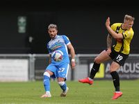 Bradley Barry of Barrow in action with Harrogate Town's  Calvin Miller during the Sky Bet League 2 match between Harrogate Town and Barrow a...
