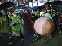 Thai protesters holding an umbrella and join a march at the Victory Monument during an anti-government protest in Bangkok, Thailand, 18 Octo...