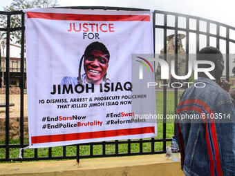 Protesters attending Sunday services next to a banner demanding justice for “JIMOH ISIAQ” who was killed in an #EndSARS protest in the Ogbom...