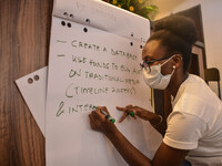 Curator of the Global Shapers Lagos Hub noting points raised by the audience on a paper board, April Amorigboye, during an Intergenerational...
