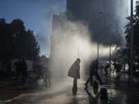 Tank throws water from riot police of carabineros de Chile (COP), tries to disperse people in the memorial rally by throwing water. 
In the...