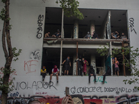 A group of people observe the demonstration from an abandoned building near Plaza Dignidad (former Plaza Italia) 
In the midst of commemora...