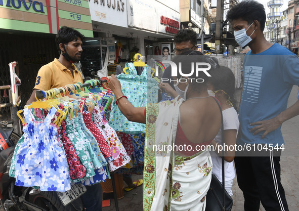 Customers buying clothes on street at Fancy Bazar ahead of Hindu Durga puja festival amidst COVID-19 coronavirus pandemic, in Guwahati, Assa...
