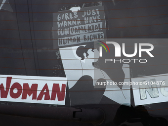 A banner 'Girls just wanna have fundamental human rights' is seen during a car demonstration organized by Women's Strike against imposing fu...