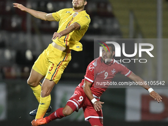 Radu Dragusin of Romania U21 in action against Omar Elouni of Malta U21 during the soccer match between Romania U21 and Malta U21 of the Qua...