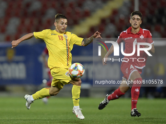 Alexandru Matan of Romania U21 in action against Owen Spiteri of Malta U21 during the soccer match between Romania U21 and Malta U21 of the...