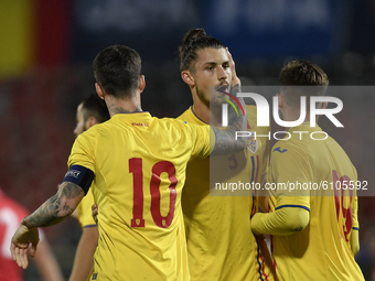 Radu Dragusin, Dennis Man and Denis Harut of Romania U21 celebrate during the soccer match between Romania U21 and Malta U21 of the Qualifyi...