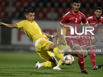 George Ganea of Romania U21 in action against Christian Gauci of Malta U21 during  the soccer match between Romania U21 and Malta U21 of the...