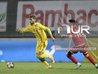 Denis Dragus of Romania U21 in action against Matthew Farrugia of Malta U21 during the soccer match between Romania U21 and Malta U21 of the...