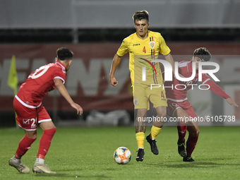 Stefan Vladoiu of Romania U21 in action against Andrea Zamit of Malta U21 during the soccer match between Romania U21 and Malta U21 of the Q...