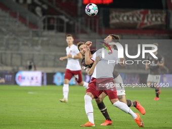 Guido Burgstaller of FC St. Pauli and Enrico Valentini of 1. FC Nuernberg battle for the ball during the Second Bundesliga match between FC...