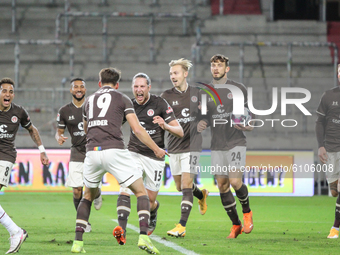 Daniel Buballa of FC St. Pauli celebrates with teammates after scoring his team's second goal during the Second Bundesliga match between FC...