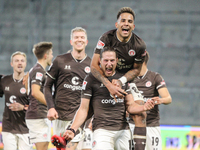 Daniel Buballa of FC St. Pauli celebrates with teammates after scoring his team's second goal during the Second Bundesliga match between FC...