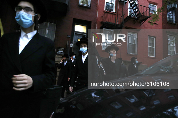 Worshipers of the Congregation Yetev Lev D'Satmar synagogue gather outside New York Citys' neighborhood of Williamsburg in the borough of Br...