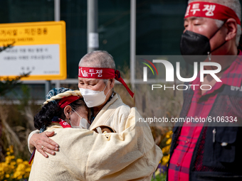 Merchants from the Federation of Street vendors comforting each other during a press conference in front of the Mapo district office on Octo...