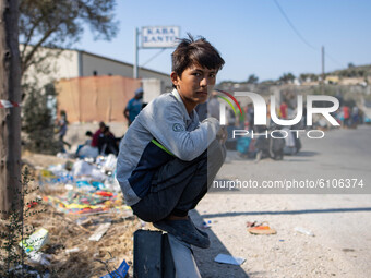 A boy near moria refugee camp. Portraits of young children refugees, minors boys and girls, asylum seekers from various countries such as Sy...